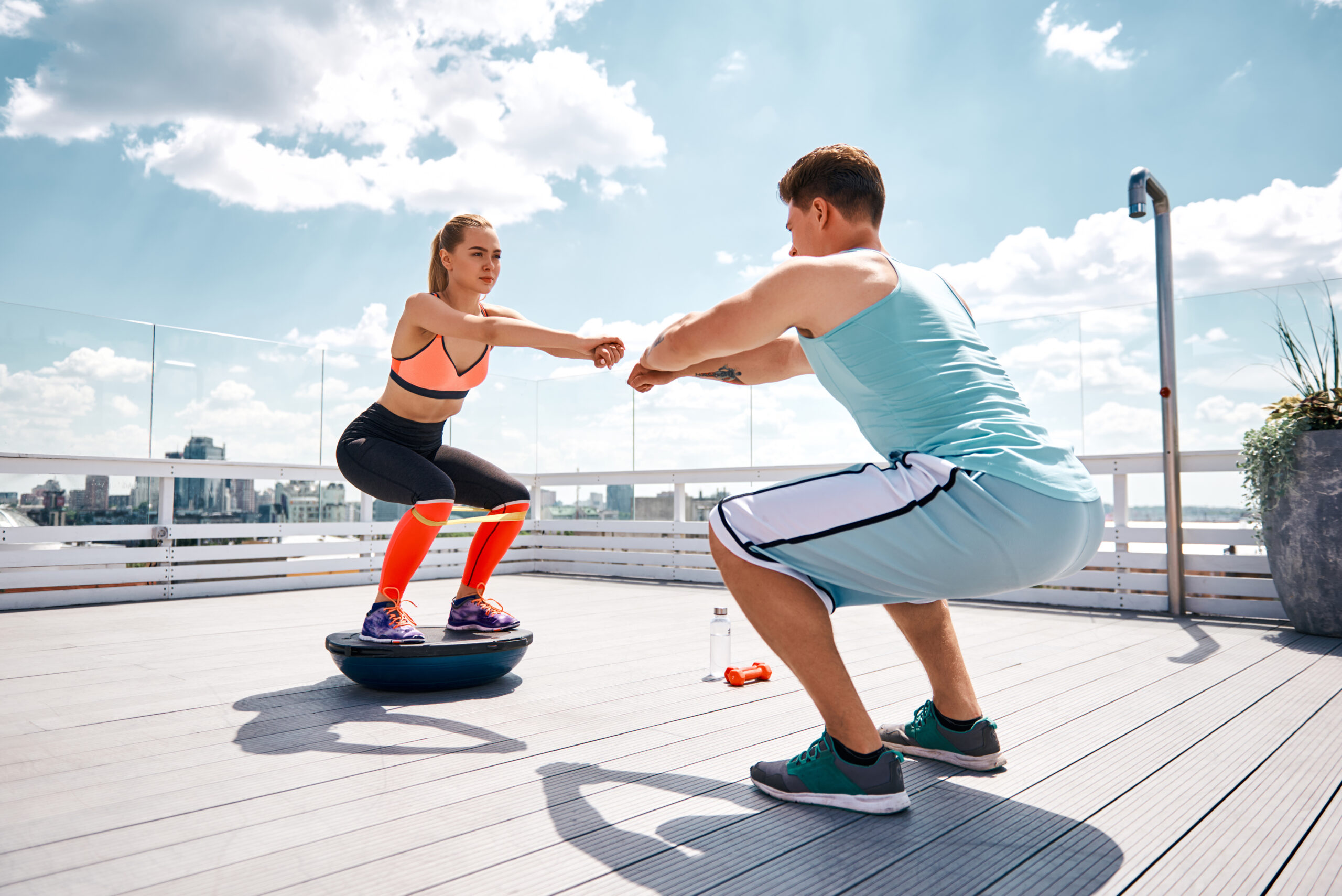 Man and woman doing outdoor fitness exercises