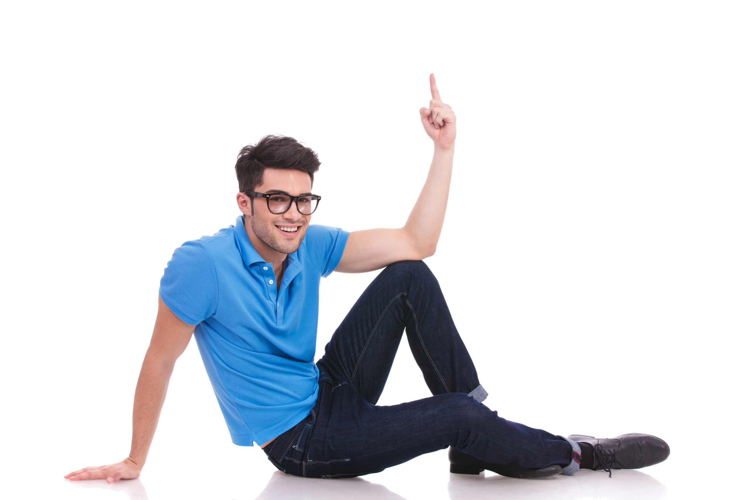 Man sitting, pointing up, wearing glasses and blue shirt