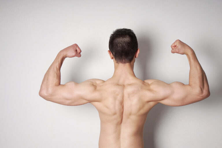Man flexing back muscles, showing strength