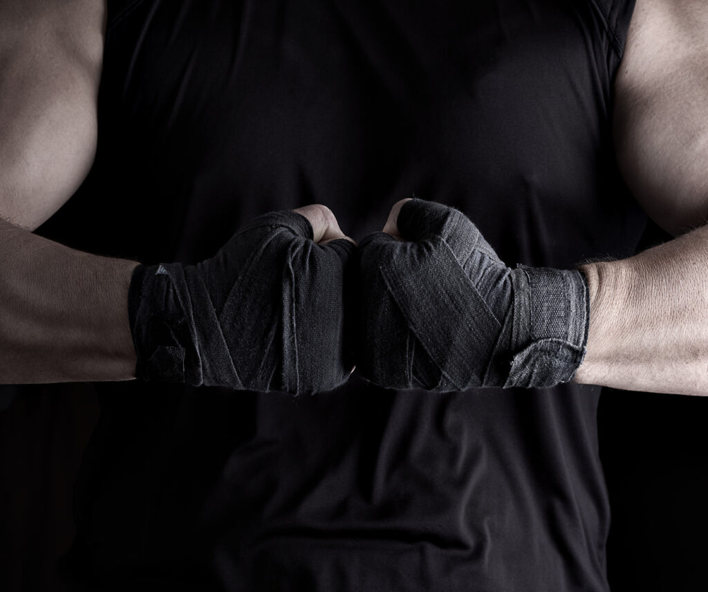 Athlete with wrapped fists in fighting stance