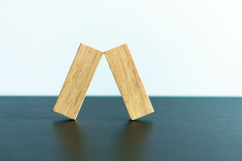 Balanced wooden blocks on dark surface