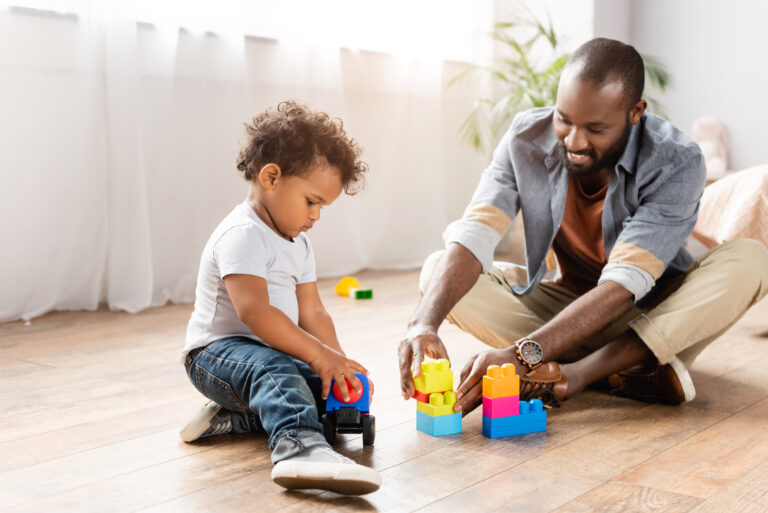 Father and child playing with building blocks
