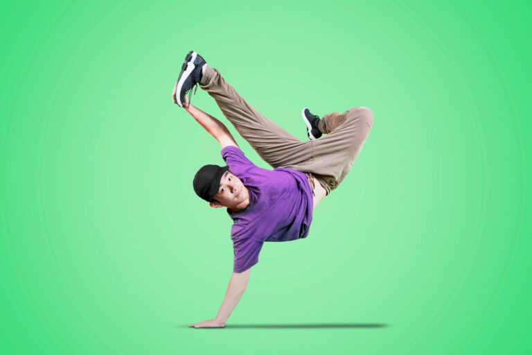 Person breakdancing against green background.
