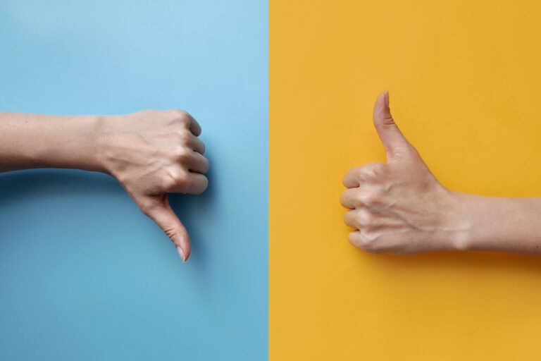 Thumbs up and down on colorful background