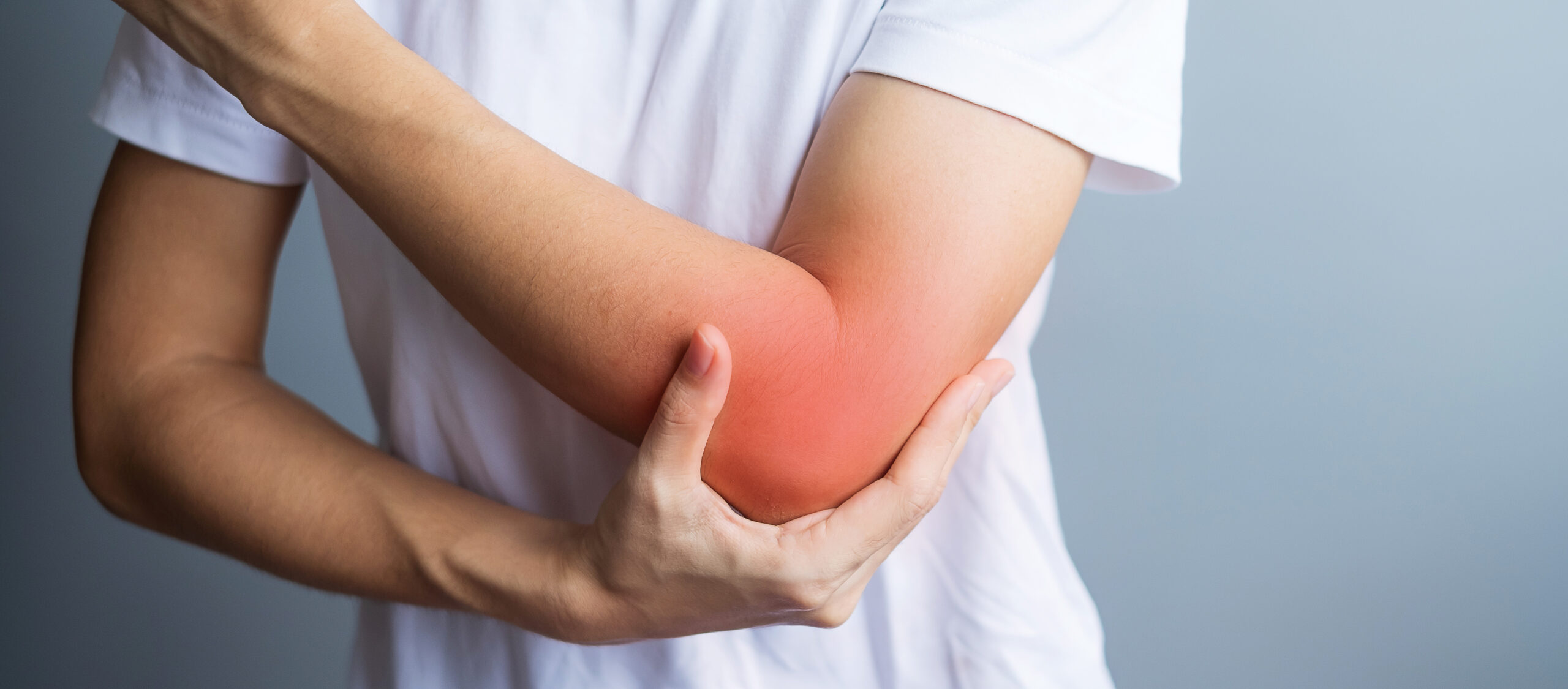 Person holding red swollen elbow, pain relief concept.
