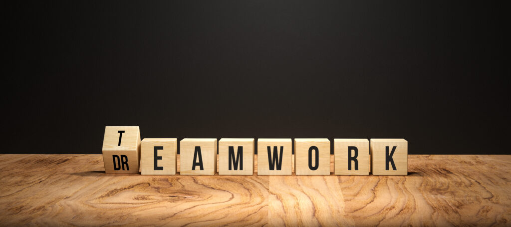 Teamwork spelled with wooden blocks on table
