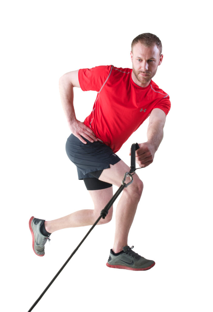 Man exercising with resistance band.