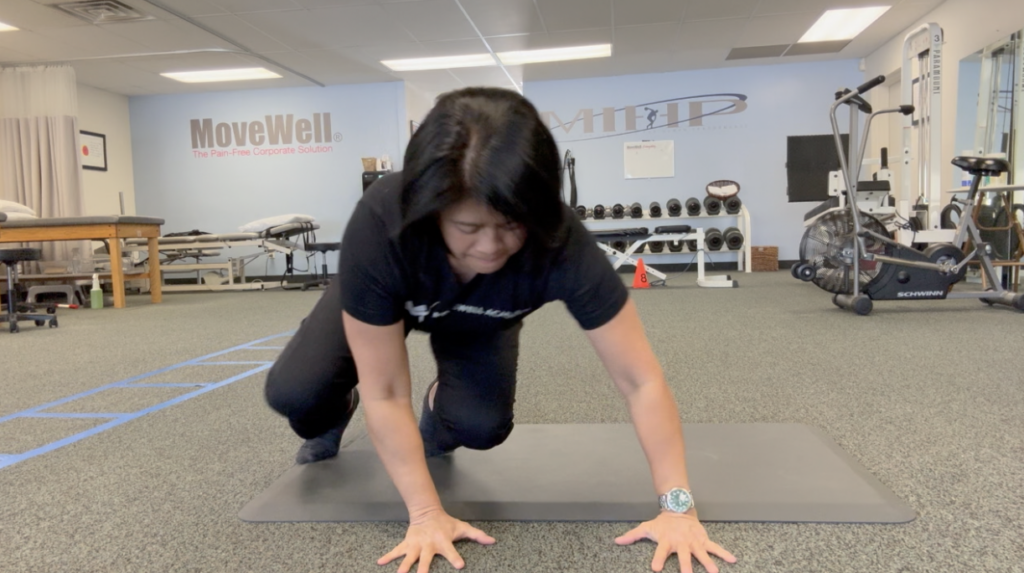 Person doing mountain climbers in a gym room.