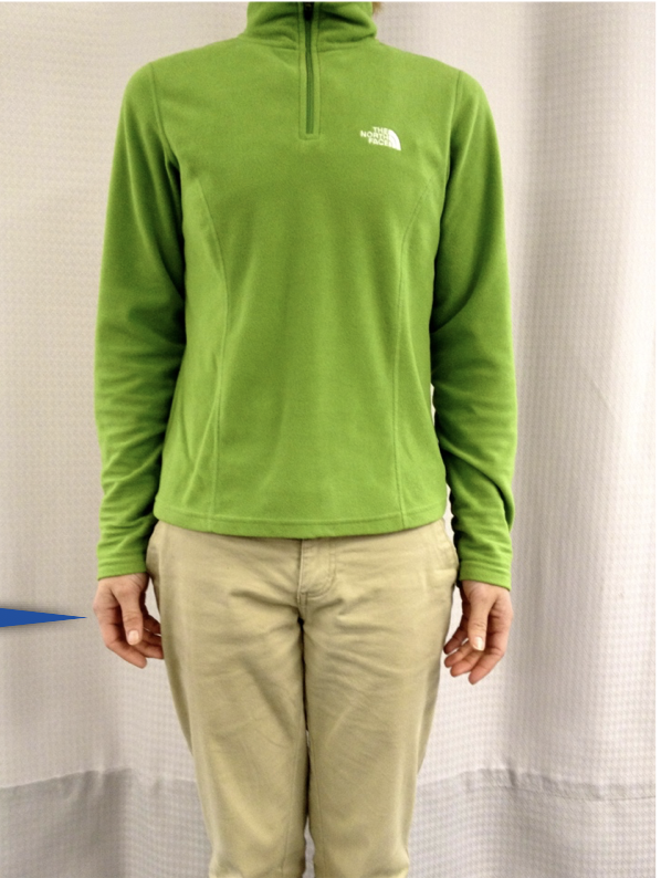 Person wearing green pullover and khaki pants.