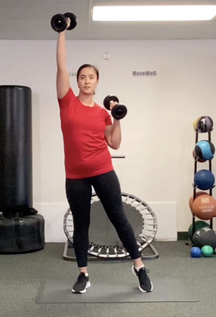 Woman lifting dumbbells in a gym setting