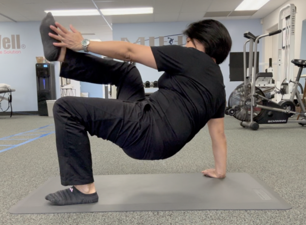 Person doing a fitness stretch on mat