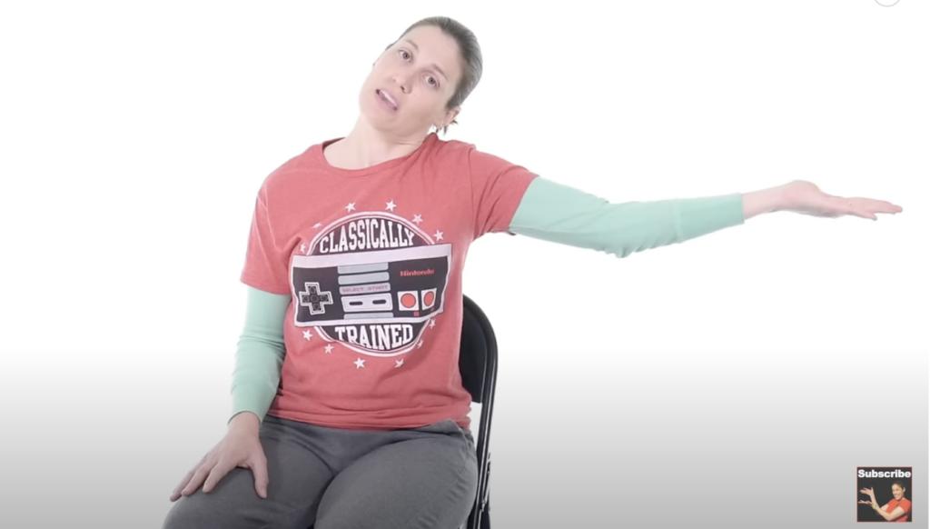 Person demonstrating shoulder stretch exercise on chair.