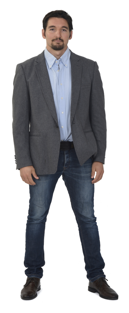 Man wearing blazer, shirt, jeans, and brown shoes.