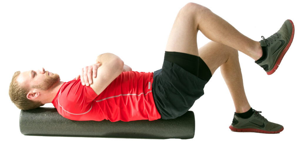 Man foam rolling back exercise on mat